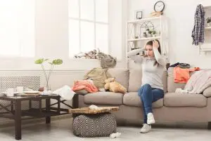 Woman in messy living room.